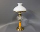 Kerosene table lamp with orange glass stem and brass foot from around the year 
1880.
