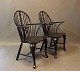 Black painted Windsor armchairs in wood from the 1880s. 

