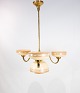 Ceiling pendant of brass and shades of opaline glass from the 1940s.
