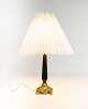 Table lamp with black patinated stem and gilded foot with shade of paper.
